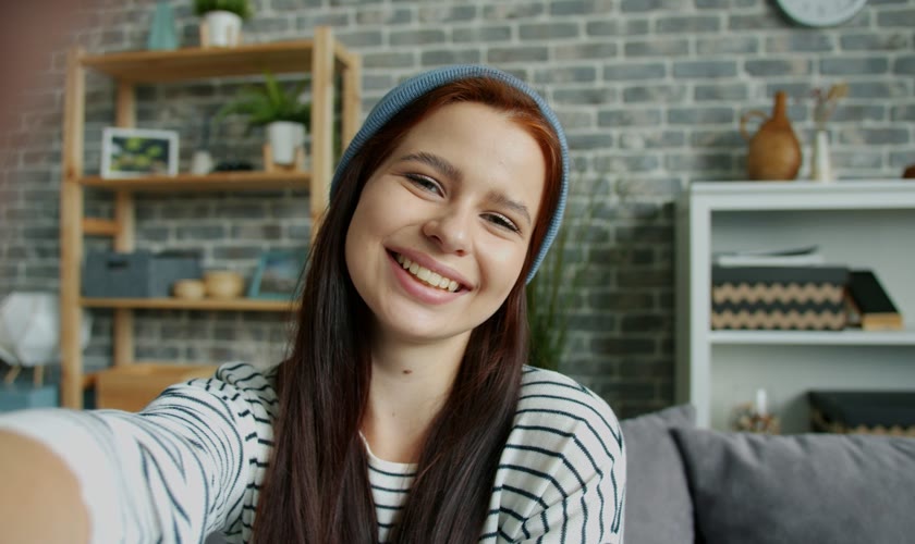 A person smiling at the camera, seen in the notch’s mirror